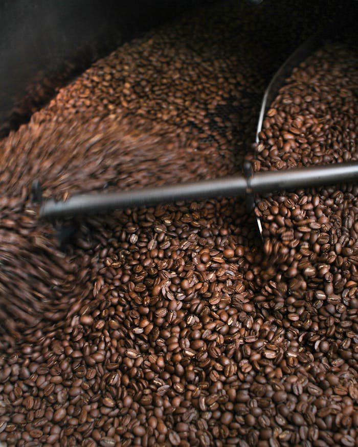 A dynamic close-up of coffee beans being roasted, highlighting the process.